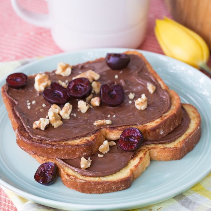 Toast topped with chocolate spread and hazelnuts