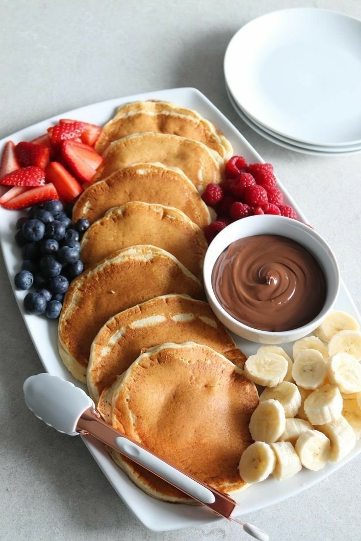 Creamy chocolate spread on pancakes